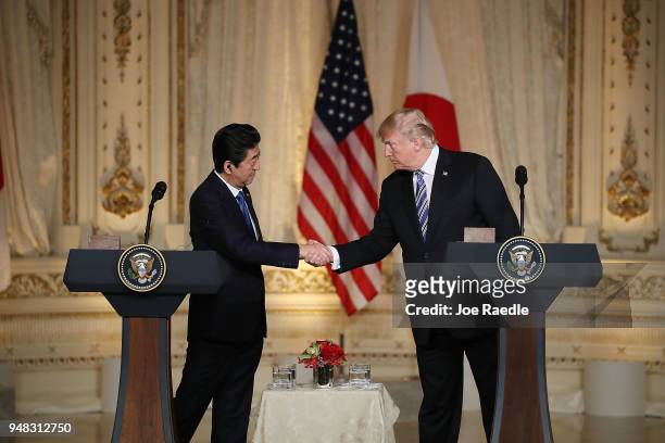 President Donald Trump and Japanese Prime Minister Shinzo Abe shake hands at a news conference at Mar-a-Lago resort on April 18, 2018 in West Palm...