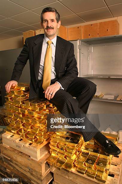 Robert R. McEwen, chairman of Goldcorp Inc., sits on a stack of gold bars in his company's vault Thursday, February 17 in Toronto, Ontario Canada.