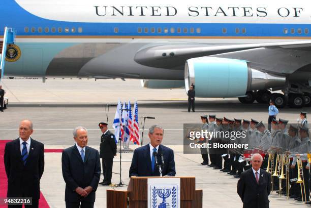 President George W. Bush, center, speaks on his arrival at Ben Gurion Airport, as Ehud Olmert, Israel's prime minister, far left, and Shimon Peres,...
