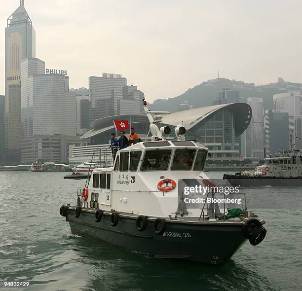 Hong Kong Marine Department and police boats patrol an exclusion zone surrounding the Hong Kong Convention and Exhibition Center, behind, as the...