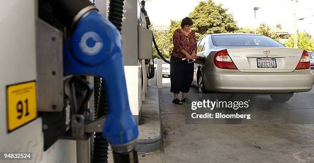 Woman fills her car at a Berkely, California Chevron gas station on April 30, 2004. ChevronTexaco Corp., the second-biggest U.S. Oil producer, said...