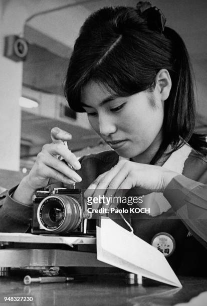 Girl working along the assembly line of the modern Nikon camera factory, Tokyo, Japan in 1970.
