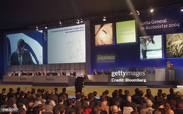 Cesar Alierta, chief executive of Telefonica SA is seen on a giant screen as he speaks at a meeting in Madrid, Spain, Friday, April 30, 2004....