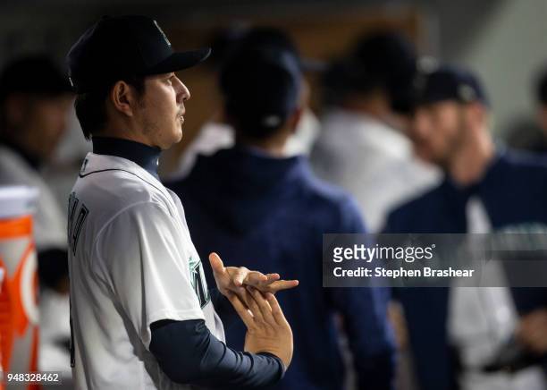 Hisashi Iwakuma of the Seattle Mariners stretches in the dugout before a game against the Oakland Athletics at Safeco Field on April 14, 2018 in...