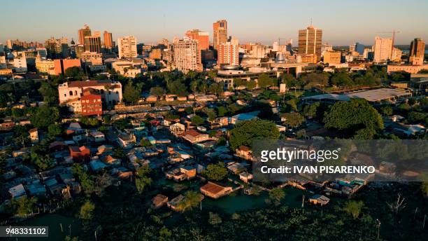 Aerial view captured with a drone of a flooded shantytown in the surroundings of Paraguay's National Congress in Asuncion on April 17, 2018. -...