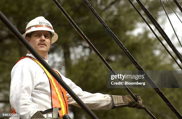 Verizon outside technician Bill Ford, of Philadelphia, Pennsylvania, works on installing an aerial fiber optic high speed cable in Ambler,...