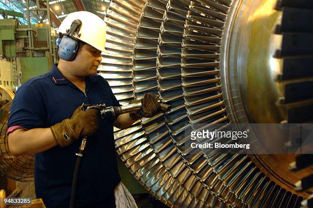 An employee works on the turbines and generators production line at Doosan Heavy Industries & Construction Co.'s Changwon plant in Changwon, South...