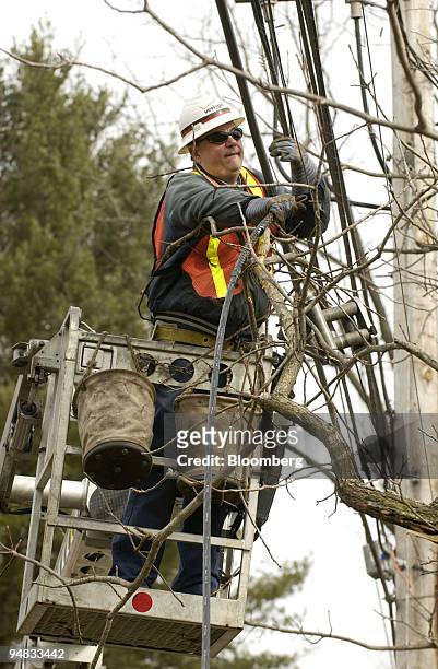Verizon outside technician John Thomas, of Philadelphia, Pennsylvania, works on installing an aerial fiber optic high speed cable in Ambler,...