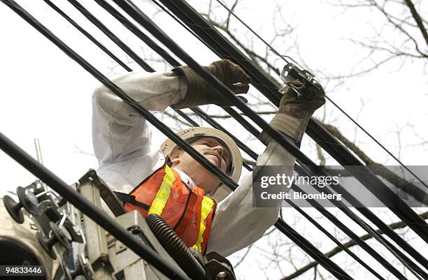Verizon outside technician Bill Ford, of Philadelphia, Pennsylvania, works on installing an aerial fiber optic high speed cable in Ambler,...