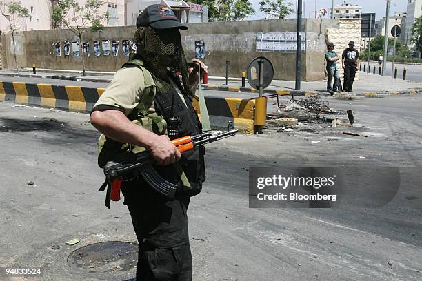 Masked Shiite gunmen stands guard during clashes in Beirut, Lebanon, on Friday, May 9, 2008. Gunfights raged across western and southern Beirut,...