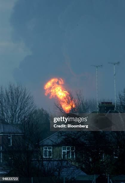 Flames rise over houses surrounding the Buncefield Fuel Depot, in Hemel Hempstead, England, Sunday, December 11, 2005. The depot operated by Total SA...