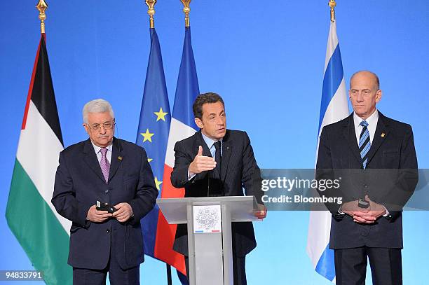 Nicolas Sarkozy, France's president, center, speaks as Mahmoud Abbas, president of the Palestinian Authority, left, and Ehud Olmert, Israel's prime...