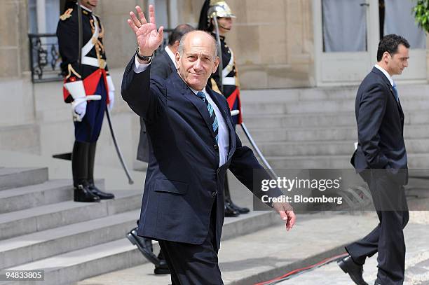 Ehud Olmert, Israel's prime minister, waves at the Elysee Palace in Paris, France, during the European Union-Mediterranean Summit on Sunday, July 13,...