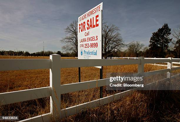 For sale sign hangs on the edge of a 10 acre lot in Newton, Kansas Tuesday, February 28, 2006. Home resales fell 10 percent in the Northeast, 7.7...