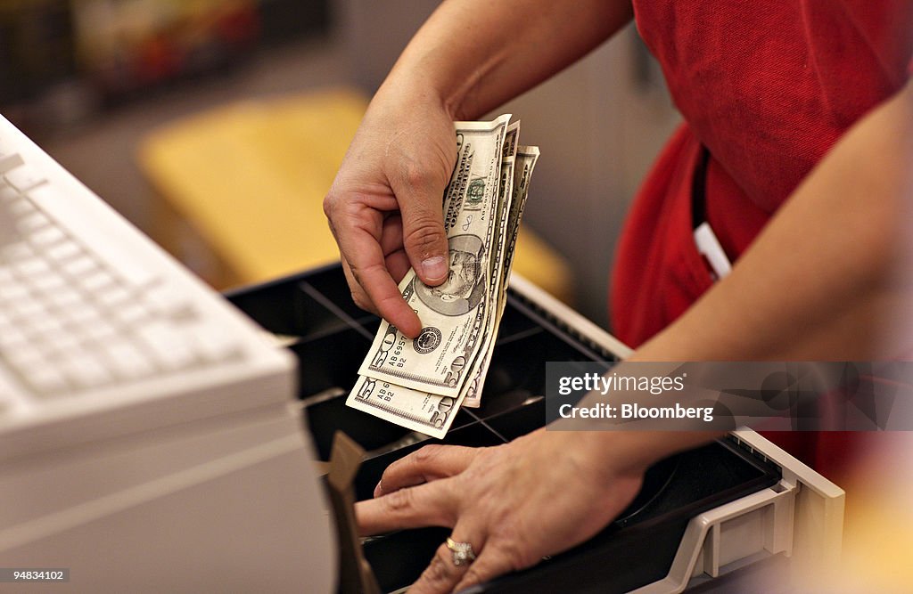 A cashier puts cash into a register inside a Super Target st