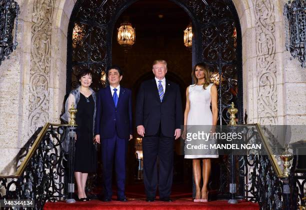 President Donald Trump and First Lady Melania Trump greet Japan's Prime Minister Shinzo Abe and his wife Akie Abe ahead of a dinner at Trump's...