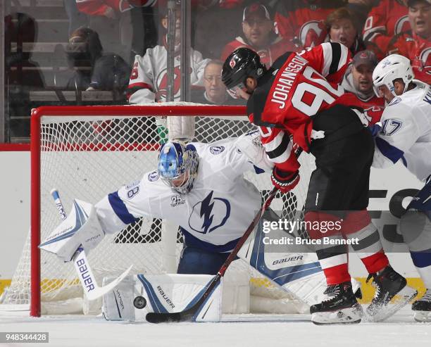 Andrei Vasilevskiy of the Tampa Bay Lightning makes the first period save as Marcus Johansson of the New Jersey Devils looks for the rebound in Game...