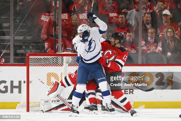 Cory Schneider and Ben Lovejoy of the New Jersey Devils defend the net against Alex Killorn of the Tampa Bay Lightning in Game Four of the Eastern...