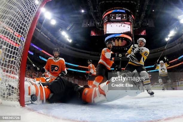 Brian Elliott of the Philadelphia Flyers is unable to stop a shot from Evgeni Malkin of the Pittsburgh Penguins as Andrew MacDonald of the...