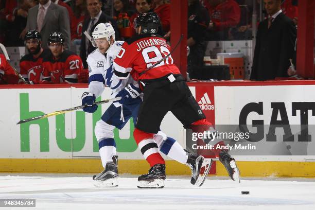 Steven Stamkos of the Tampa Bay Lightning battles against Marcus Johansson of the New Jersey Devils in Game Four of the Eastern Conference First...