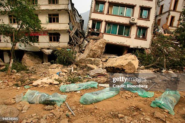 Bodies of earthquake victims are covered in plastic in Beichuan, China, on Friday, May 16, 2008. Russia, Japan and Taiwan joined China's rescue...