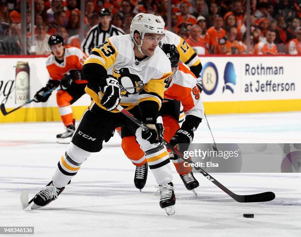 Conor Sheary of the Pittsburgh Penguins takes the puck as Ivan Provorov of the Philadelphia Flyers defends in the first period in Game Four of the...