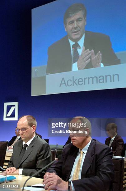 Deutsche Bank Head of Retail Banking Rainer Neske, left, and Deutsche Bank Head of Private Wealth Management Pierre de Weck listen as Chief Executive...