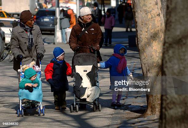 Mary Bollou, left, nanny of Carl, in stroller, and Grace Dupont, right, walk down Amsterdam Avenue with Margo Husted, 2nd right, and her son Jake...