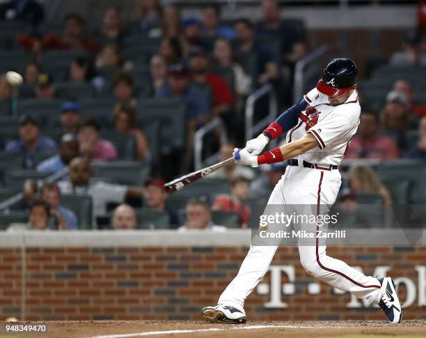 Third baseman Ryan Flaherty of the Atlanta Braves hits a 3-run home run in the fifth inning during the game against the Philadelphia Phillies at...