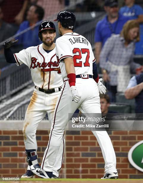 Third baseman Ryan Flaherty of the Atlanta Braves is congratulated by centerfielder Ender Inciarte after Flaherty hits a 3-run home run in the fifth...