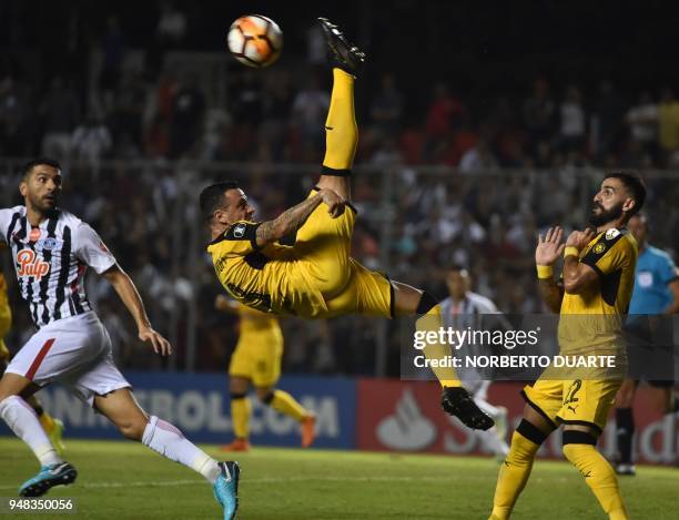 Fabian Estoyanoff of Uruguay's Penarol kicks the ball next to Santiago Salcedo of Paraguay's Libertad during their 2018 Libertadores Cup football...