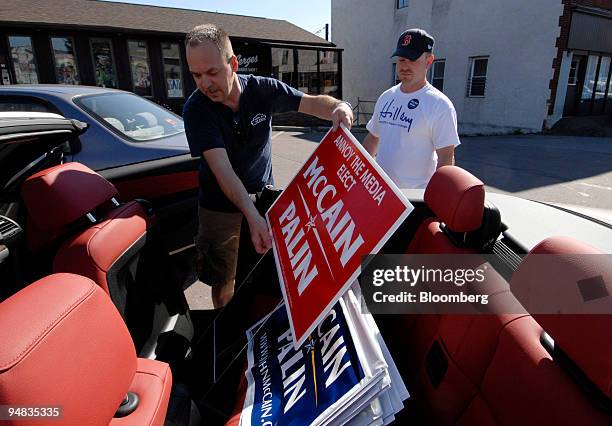Perry Aleski, of Wilkes-Barre, Pennsylvania, left, loads McCain signs into his car as volunteer Ralph Gramazio, of Quincy, Massachusetts, looks on...