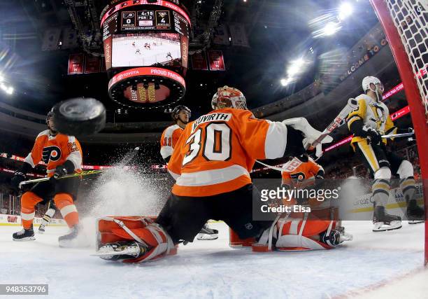Michal Neuvirth of the Philadelphia Flyers is unable to stop a shot by Riley Sheahan of the Pittsburgh Penguins in the third period in Game Four of...