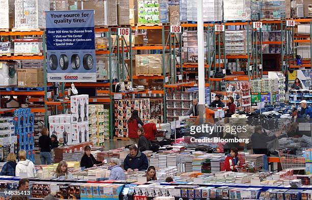 Customers shop at a Costco store in Arvada, Colorado on Friday, December 9, 2005. Sales at U.S. Wholesalers rose 1.2 percent in October, exceeding a...