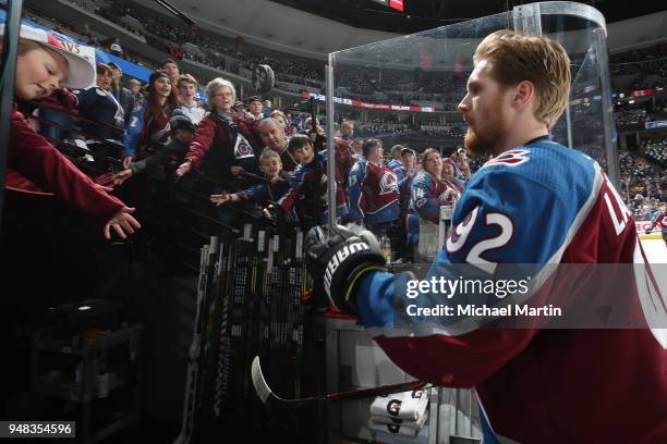 Gabriel Landeskog of the Colorado Avalanche tosses a puck to a fan before heading back to the locker room prior to the game against the Nashville...