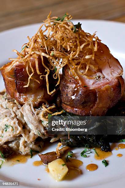 Serving of roulade of rabbit, celery root, apples, bacon and chanterelles is arranged for a photo at Freemans, a restaurant located at the end of...