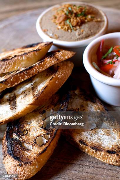 Serving of chicken liver crostini and pickled vegetables is arranged for a photo at Freemans, a restaurant located at the end of Freeman Alley off...