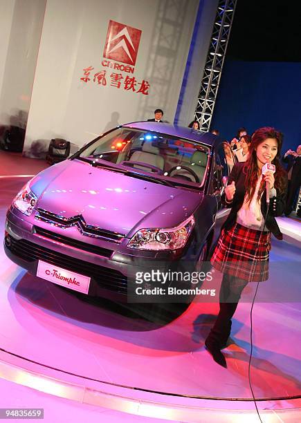 Television journalist reports on the Dongfeng-Citroen's new car for the Chinese market, the C-Triomphe, during its launching conference in Shenzhen,...