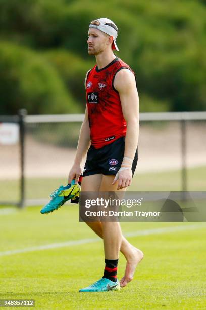 Shaun McKernan of the Bombers changes his boots during an Essendon Bombers traing session on April 19, 2018 in Melbourne, Australia.