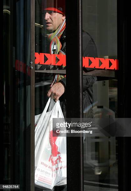 Shopper exits the Astor Place Kmart store in New York on Tuesday, February 14, 2006. Retailers rang up their biggest sales gains since May 2004 last...