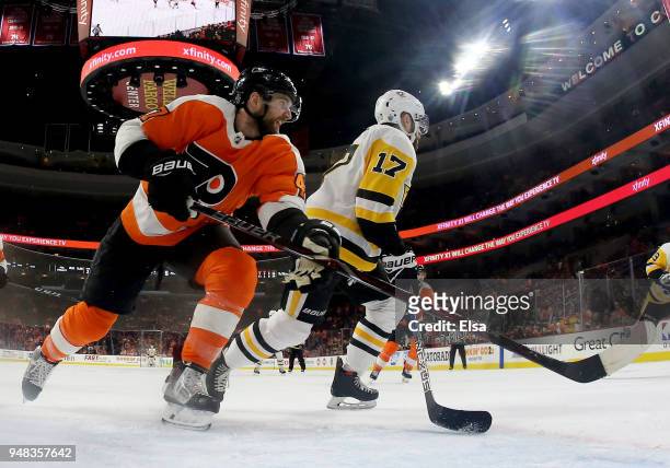 Andrew MacDonald of the Philadelphia Flyers and Bryan Rust of the Pittsburgh Penguins fight for position in the third period in Game Four of the...