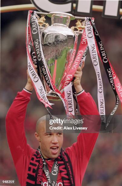 Mikael Silvestre of Manchester United lifts the trophy and celebrates being crowned FA Carling Premier League Champions after the match against Derby...