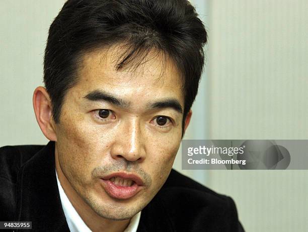 Fast Retailing Senior Vice President Naoki Ohtoma speaks to reporters at a press briefing at the Tokyo Stock Exchange on Thursday, January 13, 2005....