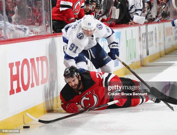 Steven Stamkos of the Tampa Bay Lightning checks Kyle Palmieri of the New Jersey Devils during the third period in Game Four of the Eastern...