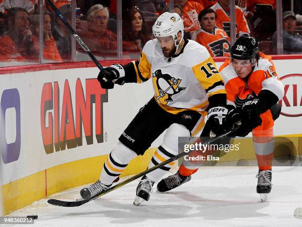 Riley Sheahan of the Pittsburgh Penguins and Nolan Patrick of the Philadelphia Flyers fight for the puck in Game Four of the Eastern Conference First...