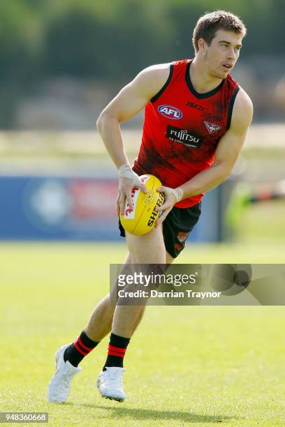 Zach Merrett of the Bombers runs with the ball during an Essendon Bombers training session on April 19, 2018 in Melbourne, Australia.