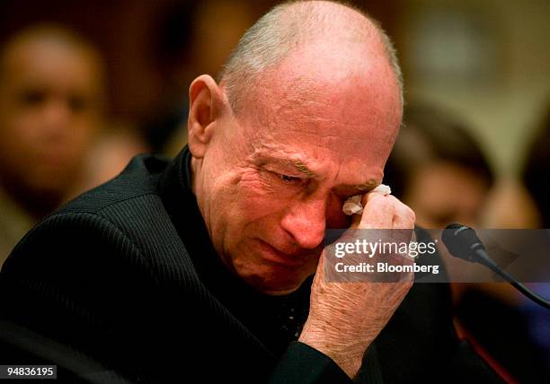 Leroy Hubley, whose wife and son died from an allergic reaction to the blood thinner heparin, wipes his eyes while testifying at a House Oversight...