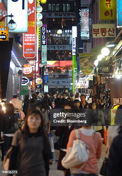 People walk through a shopping district in central Seoul, South Korea, on Wednesday, Oct. 8, 2008. South Korea's economy probably grew at the weakest...