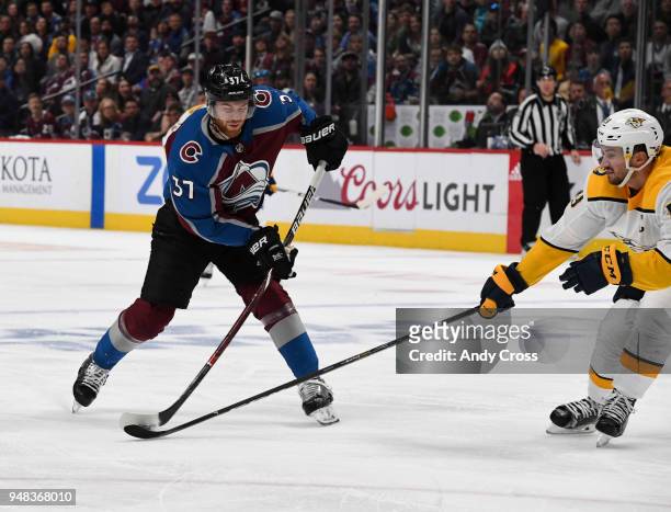 Colorado Avalanche left wing J.T. Compher shoots against Nashville Predators defenseman Roman Josi in the first period during the fourth game of...