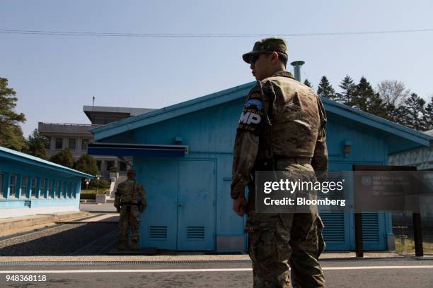 Soldiers stand guard next to the United Nations Command Military Armistice Commission conference buildings at the truce village of Panmunjom in the...